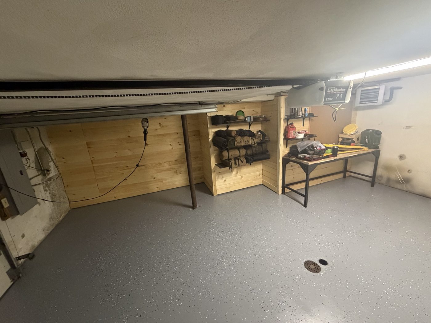 Same garage finished with a grey epoxy flake floor coating and built-in storage