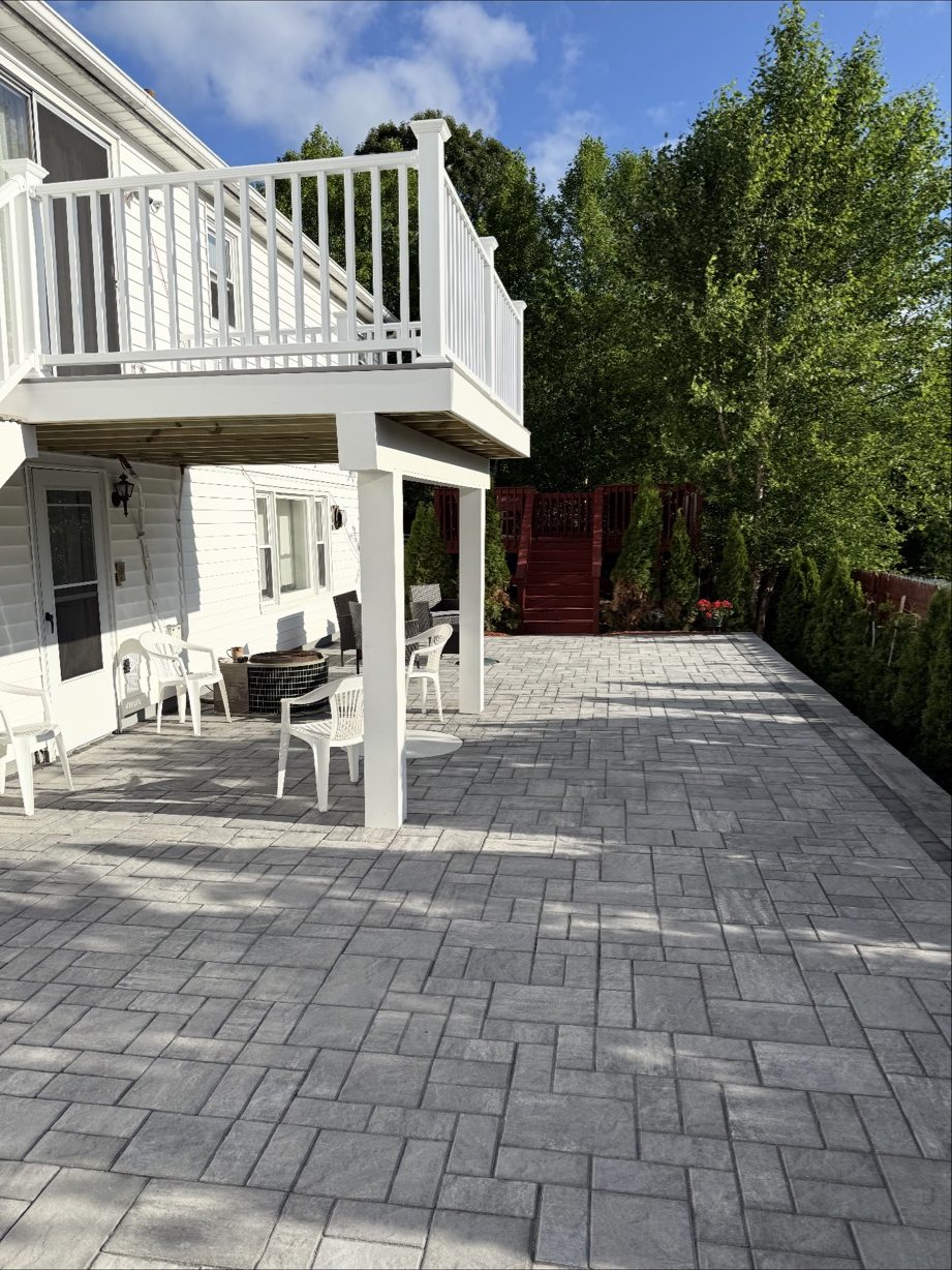 Rebuilt second-story deck with new white vinyl railing